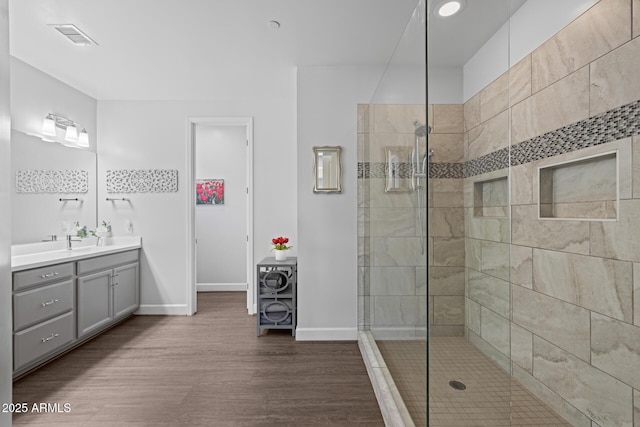 14573 W Reade Ave, Litchfield Park, AZ 85340 - bathroom featuring vanity, tiled shower, and wood finished floors