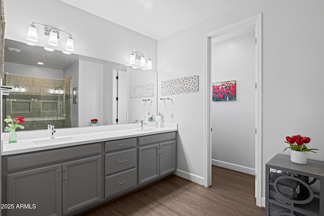 14573 W Reade Ave, Litchfield Park, AZ 85340 - full bath with double vanity, a shower stall, and wood finished floors