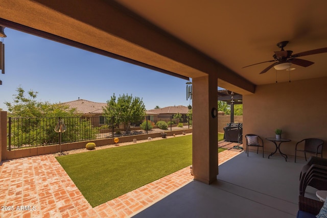 14573 W Reade Ave, Litchfield Park, AZ 85340 - fenced backyard featuring a ceiling fan and a patio