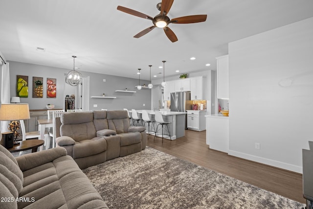 14573 W Reade Ave, Litchfield Park, AZ 85340 - living room featuring a ceiling fan, wood finished floors, recessed lighting, and a chandelier