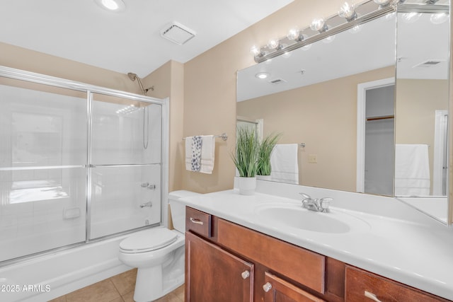 full bathroom featuring tile patterned flooring, vanity, enclosed tub / shower combo, and toilet