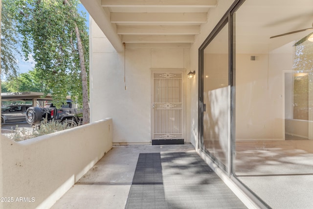 view of exterior entry with ceiling fan