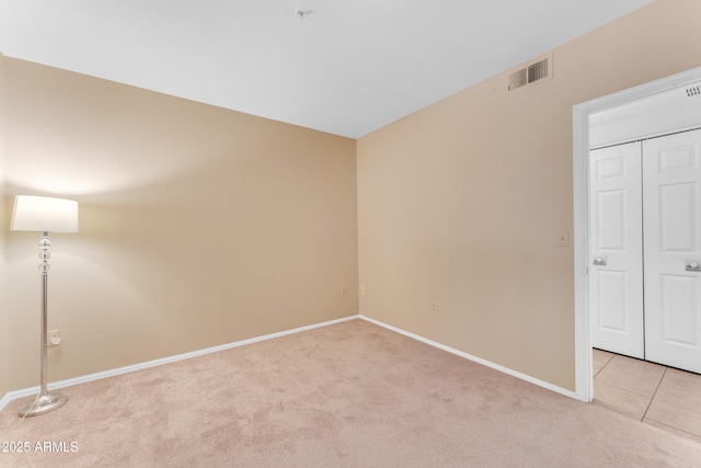 empty room featuring light carpet