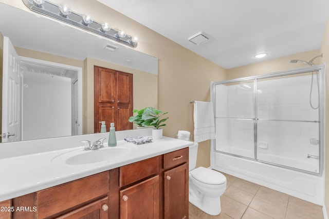 full bathroom with tile patterned flooring, vanity, toilet, and combined bath / shower with glass door