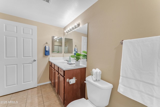 bathroom featuring toilet, vanity, and tile patterned floors