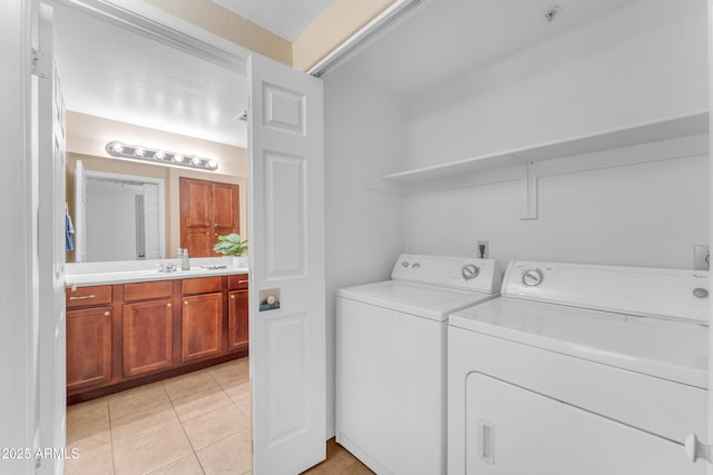 washroom featuring washing machine and clothes dryer and light tile patterned flooring