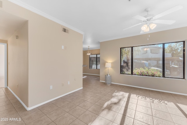 empty room with ceiling fan, light tile patterned floors, and ornamental molding