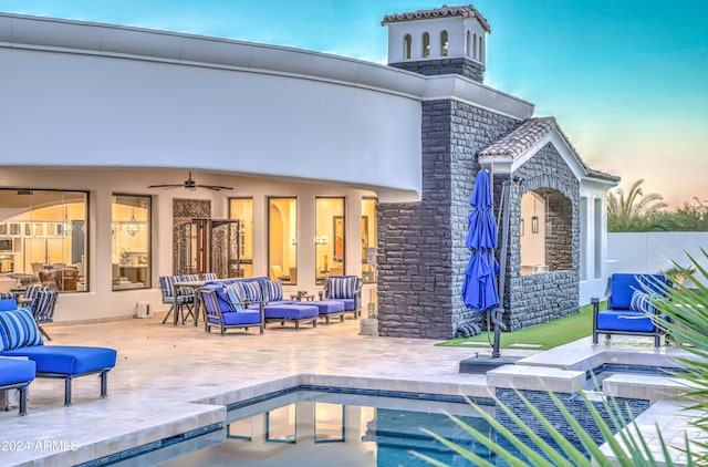 back house at dusk with an outdoor hangout area, ceiling fan, french doors, and a patio area