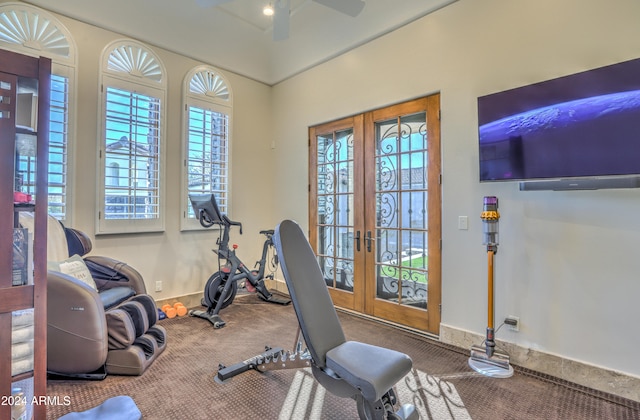 workout room with a wealth of natural light, carpet flooring, and french doors