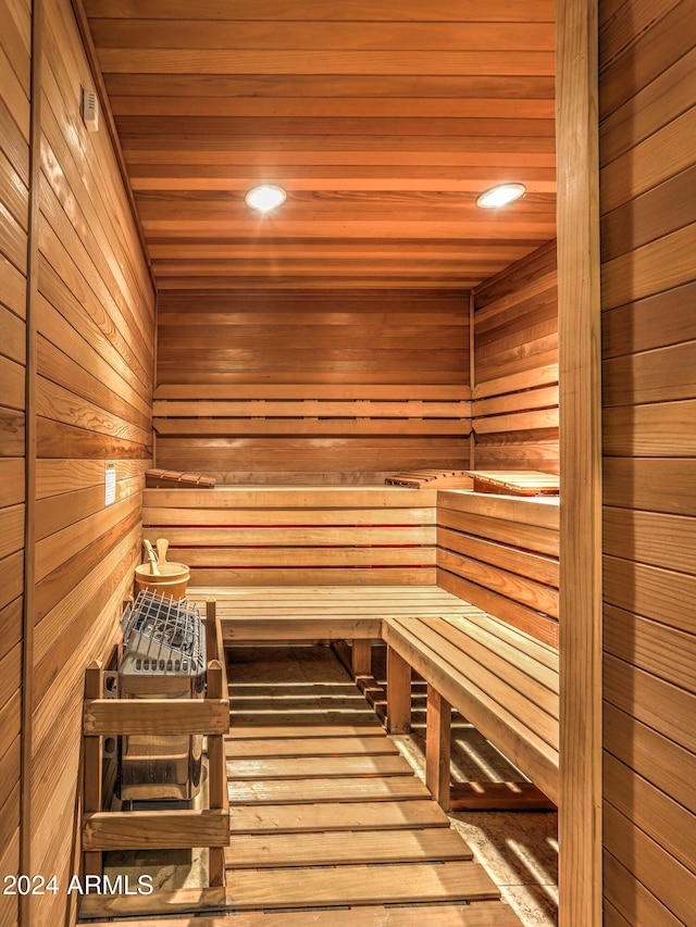 view of sauna / steam room featuring wooden walls, wood-type flooring, and wood ceiling