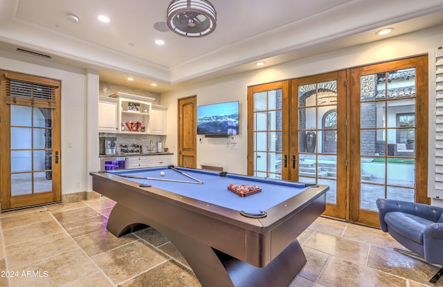 recreation room featuring pool table, french doors, and a tray ceiling