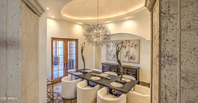 dining room featuring french doors, plenty of natural light, a chandelier, and a tray ceiling