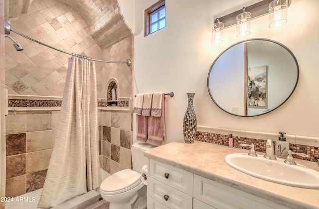 bathroom with walk in shower, vanity, toilet, and backsplash