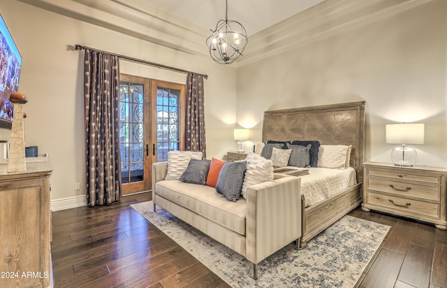 bedroom featuring dark wood-type flooring, french doors, a notable chandelier, and access to exterior