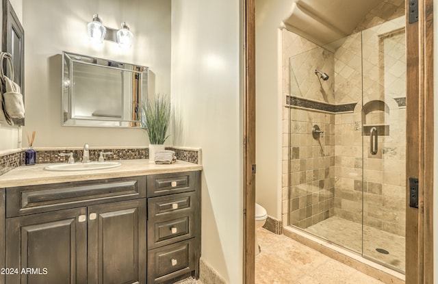 bathroom featuring vanity, toilet, and an enclosed shower