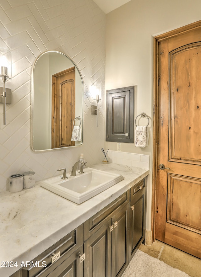 bathroom featuring vanity and backsplash