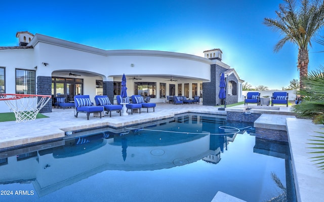 view of pool with ceiling fan and a patio