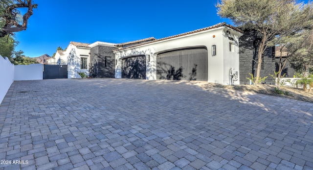 mediterranean / spanish house with a garage