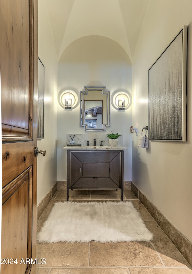 bathroom featuring vanity and vaulted ceiling