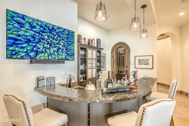 bar with pendant lighting and sink