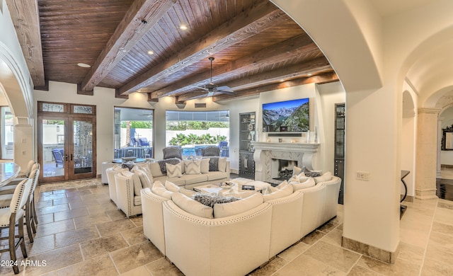 living room with ceiling fan, beamed ceiling, wood ceiling, and french doors