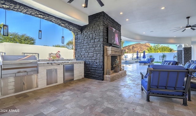 view of patio featuring ceiling fan and exterior kitchen