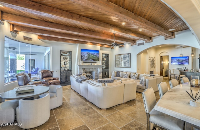 living room with wood ceiling, ceiling fan, and beam ceiling