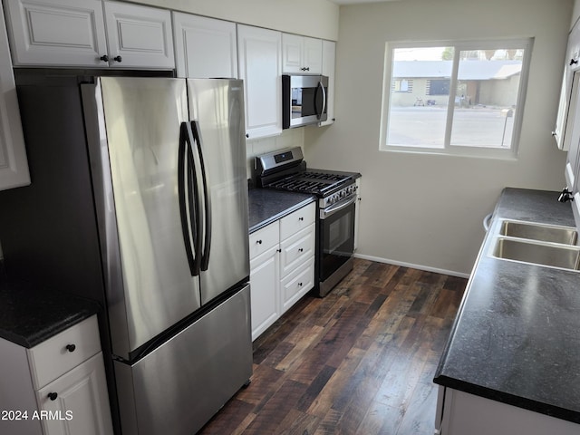 kitchen featuring white cabinetry, dark hardwood / wood-style flooring, sink, and appliances with stainless steel finishes