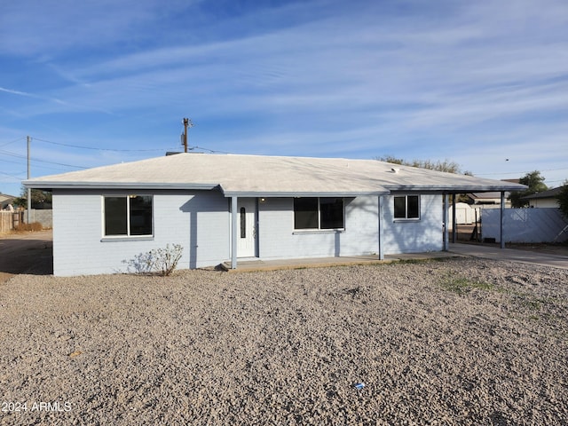 ranch-style home featuring a carport