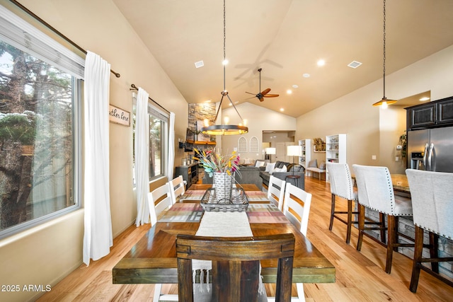 dining room featuring visible vents, plenty of natural light, a ceiling fan, and light wood-type flooring