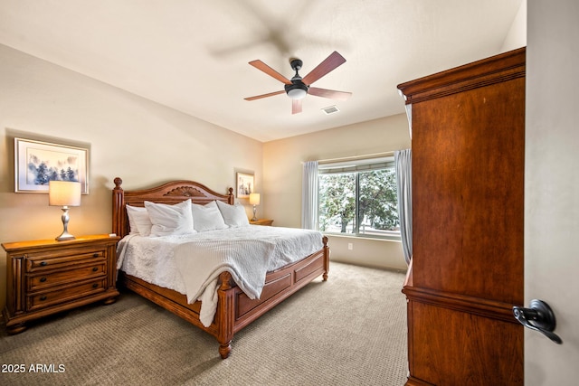 bedroom with light carpet, visible vents, and ceiling fan