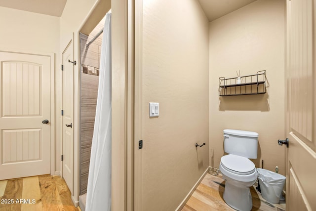 bathroom with toilet and wood finished floors