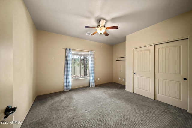 unfurnished bedroom with visible vents, a closet, carpet floors, baseboards, and ceiling fan