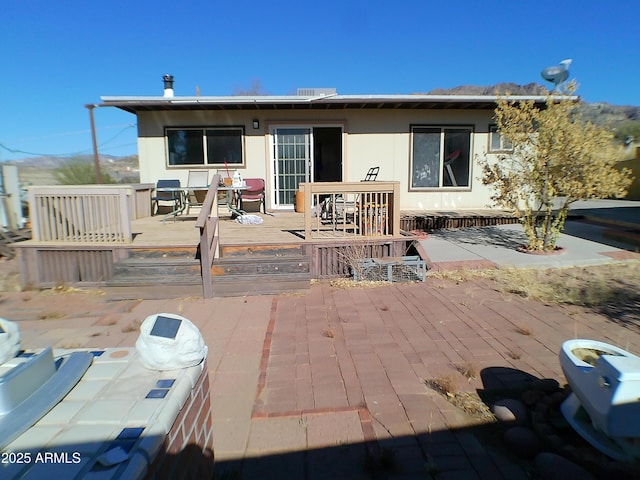 rear view of property with a wooden deck