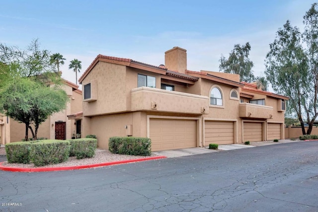 5640 E Bell Rd Unit 1099, Scottsdale, AZ 85254 - view of front of house featuring a chimney and stucco siding