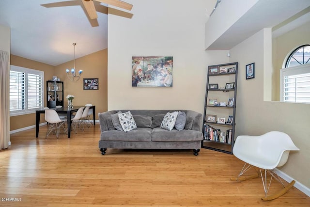 5640 E Bell Rd Unit 1099, Scottsdale, AZ 85254 - living area featuring a chandelier, plenty of natural light, light wood finished floors, and vaulted ceiling