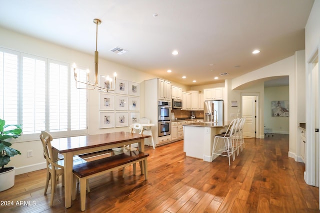 interior space featuring an inviting chandelier and light hardwood / wood-style floors