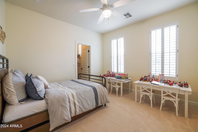 bedroom with light colored carpet and multiple windows