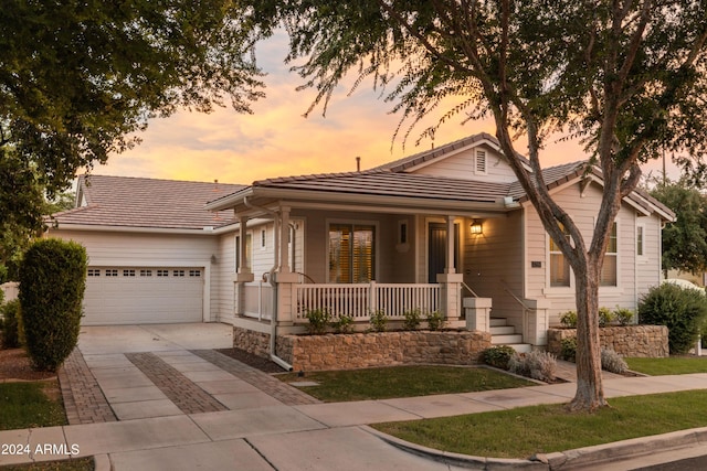 view of front facade featuring a garage and covered porch