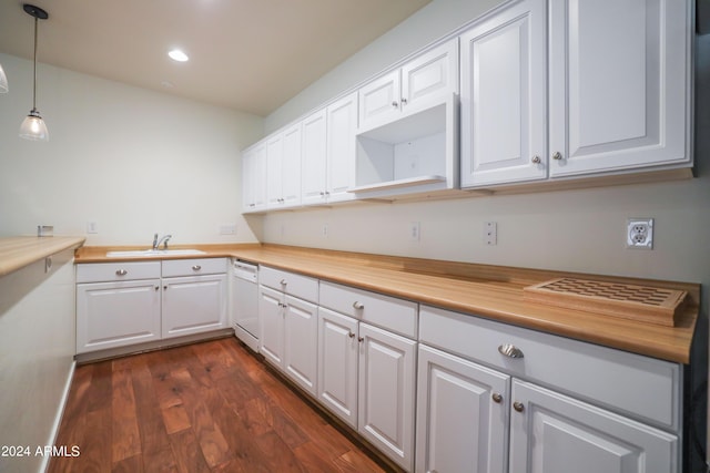 kitchen with butcher block counters, pendant lighting, dishwasher, and white cabinets