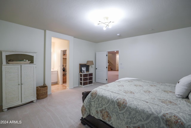 bedroom with ensuite bath and carpet floors