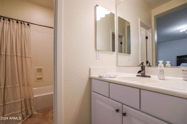 bathroom with shower / tub combo with curtain and vanity