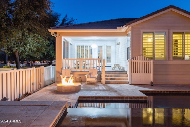 exterior space with a patio and an outdoor fire pit