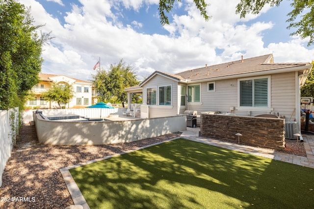 rear view of house with a yard and central air condition unit