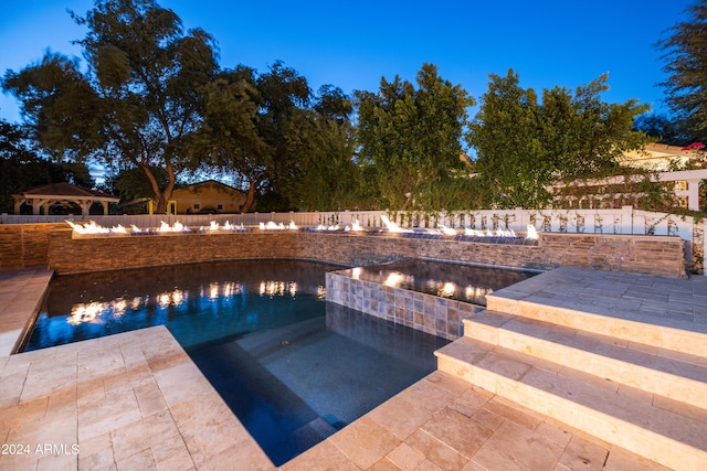 view of pool with a gazebo, a water view, an in ground hot tub, and a patio