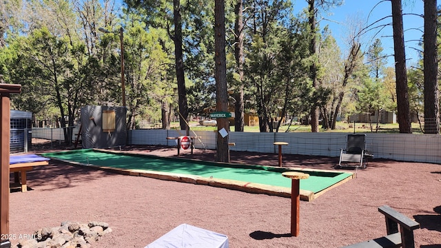 view of home's community featuring fence