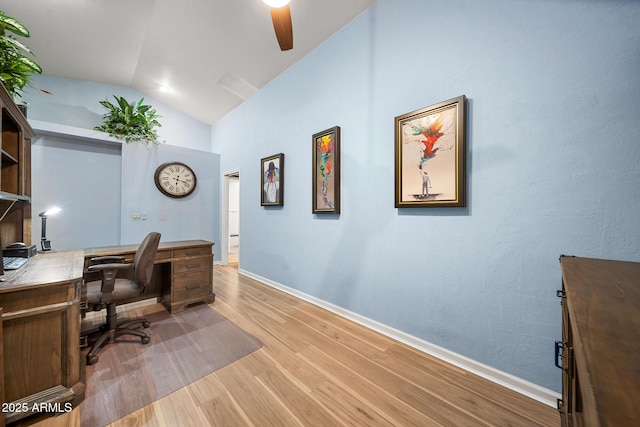 office area featuring baseboards, lofted ceiling, and wood finished floors