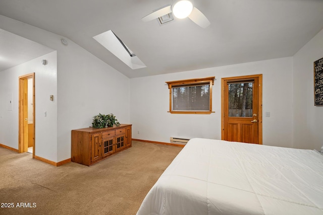 carpeted bedroom featuring a baseboard radiator, vaulted ceiling with skylight, baseboards, and a ceiling fan