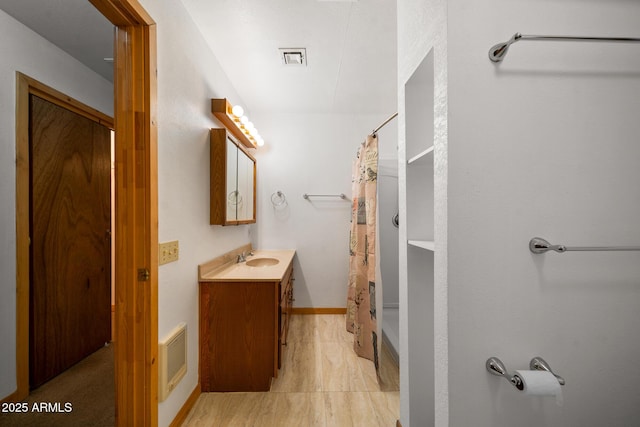 bathroom with baseboards, visible vents, vanity, and a shower with curtain