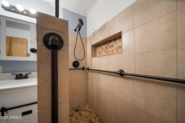 bathroom featuring vanity and tiled shower